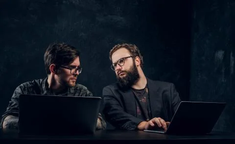 Two programmers are thinking hard, trying to find a solution to the problem in Stockfoto's