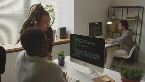 Two Programmers Discussing HTML Code on Computer in Office Stock Footage 255782522