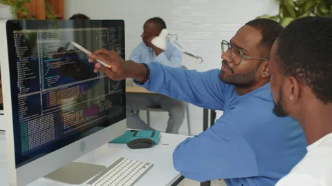 Two Programmers Fixing Bags in Script while Coding at Office Stock Footage 277412135