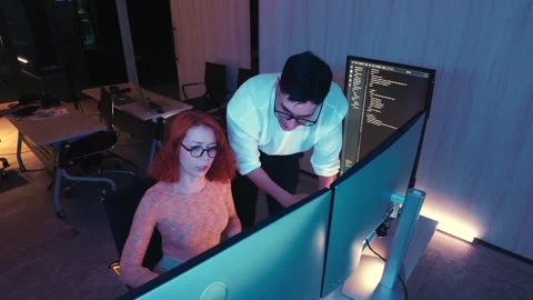 Two programmers in a modern office celebrate a coding breakthrough with highfive 動画素材 319526182
