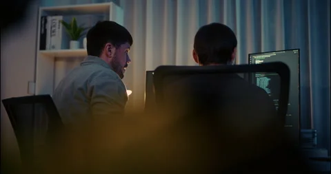 Two Programmers Working Together on Code at Night in Modern Office. Stock Footage 306739668
