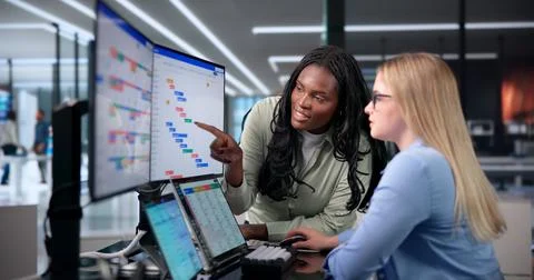 Two Project Managers Update The Agile Gantt Chart During Team Training. Stock Photos