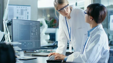 Two Prominent Computer Engineers Working with Programming Software on Computer Stock Footage 85772000