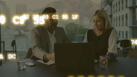Two pros reviewing laptop for tech review, man pointing, animated code drifting Stock Footage 333494256