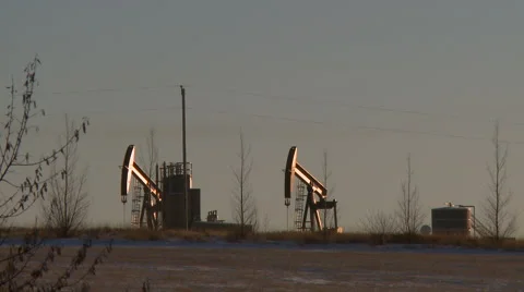 Two pumpjacks pumping crude oil Stock Footage 44615650
