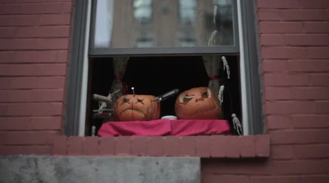 Two Pumpkin Heads in a Window - Halloween Decoration Stock Footage 63325078