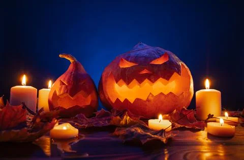 Two pumpkin lanterns with carved faces for Halloween candle lighting. Stockfoto's