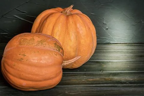 Two pumpkins on a black background. Halloween theme. Stock Photos