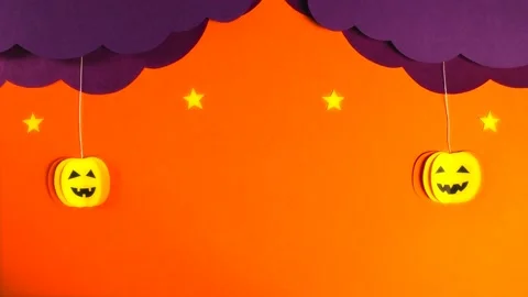Two pumpkins fall out of curly lilac clouds. Stars light up, black bats fly Stock Footage 158281897