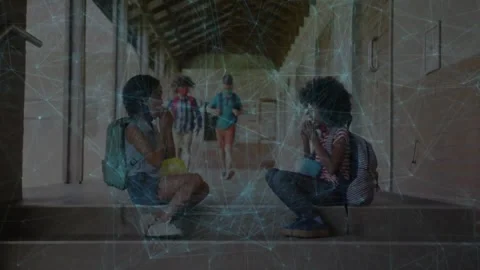 Two pupils eating snacks on school steps, network overlay tracking coming pupils Stock Footage 332405459