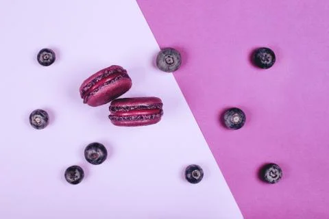 Two purple macarons on red background Stock Photos