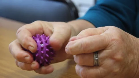 Two purple massager with thorns in hands Video stock 145357312