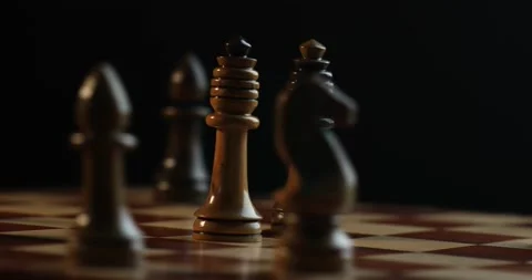 Two Queen figures spread on the chess board with flash light 4K video Stock Footage 131135245