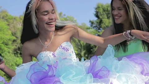 Two Quinceanera Sisters- Bothering Using the Cell Phone Stock Footage 243236610