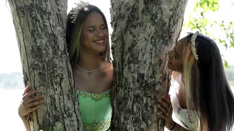 Two Quinceañera Sisters- Playing Hide and Seek in a Tree Stock Footage 243236788