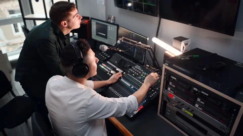 Two radio station workers in in the studio live together Stock Footage 303143569