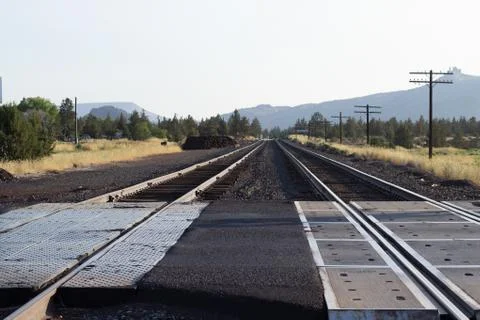 Two rail road tracks trailing into the distance in Oregon near Smith Rock. Stock Photos