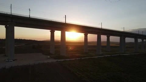 Two rails bridge crossing above fields at sunset, Israel Stock Footage 152091082