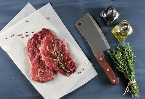 Two raw beef steak with spices, kitchen knife Stock Photos