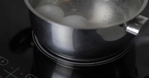 Two Raw White Chicken Eggs Hard Boiled In Stainless Pan In A Boiling Water Stock Footage 127755522