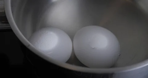 Two Raw White Chicken Eggs Hard Boiled In Stainless Pan In A Boiling Water Stock Footage 127755562
