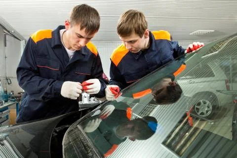 Two Real Mechanics working in Auto Repair Shop Stock Photos