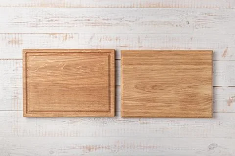 Two rectangular cutting boards with edging on a white wooden table. mockup of 写真素材