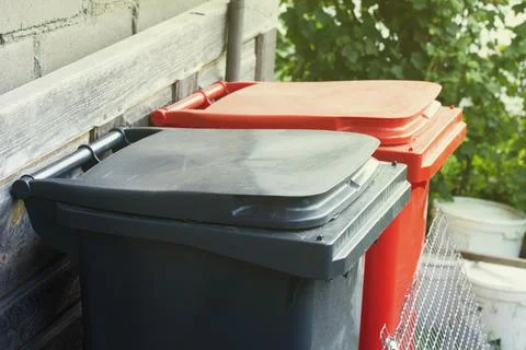 Two recycling garbage containers red and gray color. Colorful recycle bins ou 스톡 사진