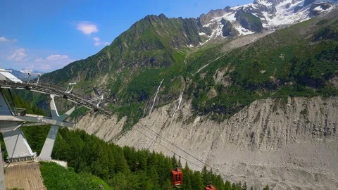 Two red aerial cableways at Mer de Glace in the French Alps Stock Footage 116734377