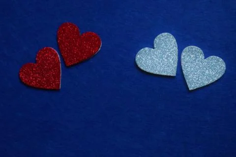Two red and two silver hearts  on classic blue background in trendy color of  Stock Photos