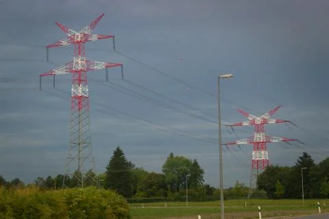 Two red and white high-voltage masts. Stock Photos