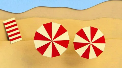 Two red and white striped beach umbrellas on sandy shore Stock Photos