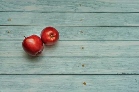Two red apples on an isolated background in the form of old boards Stock Photos
