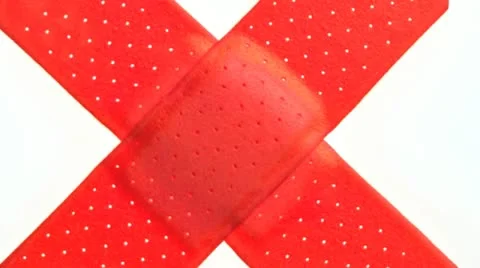 Two red band-aids in the shape of an x Stock Footage 21313042