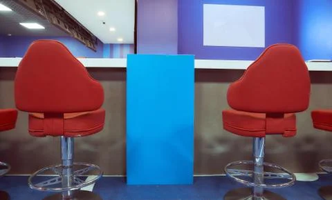 Two red bar stools in a blue interior Stock Photos