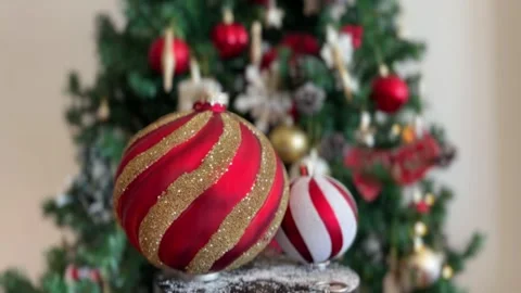 Two red baubles rotating with blurred tree Stock Footage 341611583