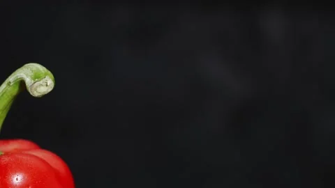 Two red bellpepper on black background with droplets Stock Footage 147286763