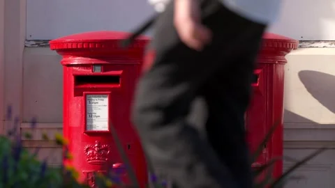Two red British Royal Mail post boxes with people walking past Stock Footage 281059208