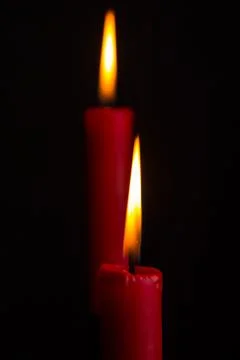 Two red candles on a black background Stock Photos
