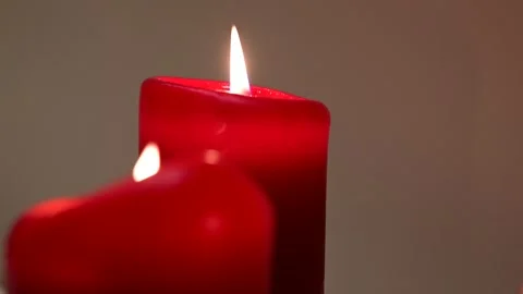 Two red candles burning Stock Footage 145025375