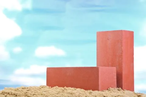 Two red ceramic bricks on the sand at the blue sky background Stock Photos
