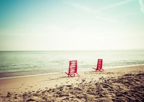 Two red chairs on the beach Stock Photos