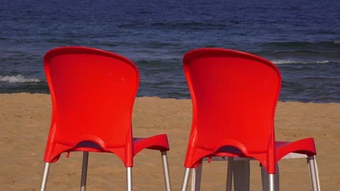 Two red chairs on the sandy beach Stock Footage 99598565
