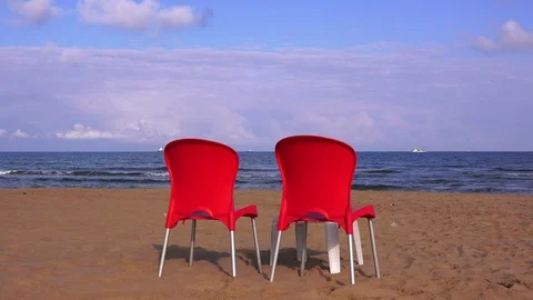 Two red chairs on the sandy beach Stock Footage 100379614