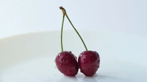 Two red cherries on a white background. Cyclic movement Stock Footage 200182019