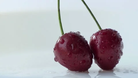 Two red cherries on a white background. Cyclic movement Stock Footage 202189049