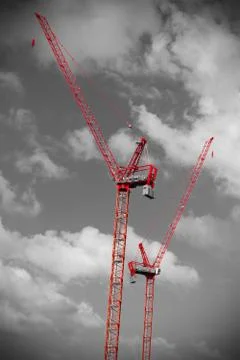 Two red construction cranes Stock Photos