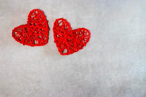 Two red decorative hearts on a gray background. Valentine's Day Concept. Stock Photos