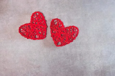 Two red decorative hearts on a gray background. Valentine's Day Concept. Stock Photos