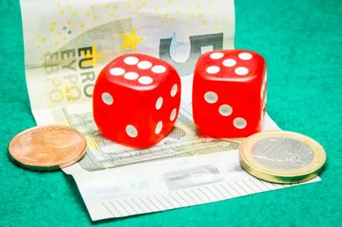 Two red dice with euros Stock Photos